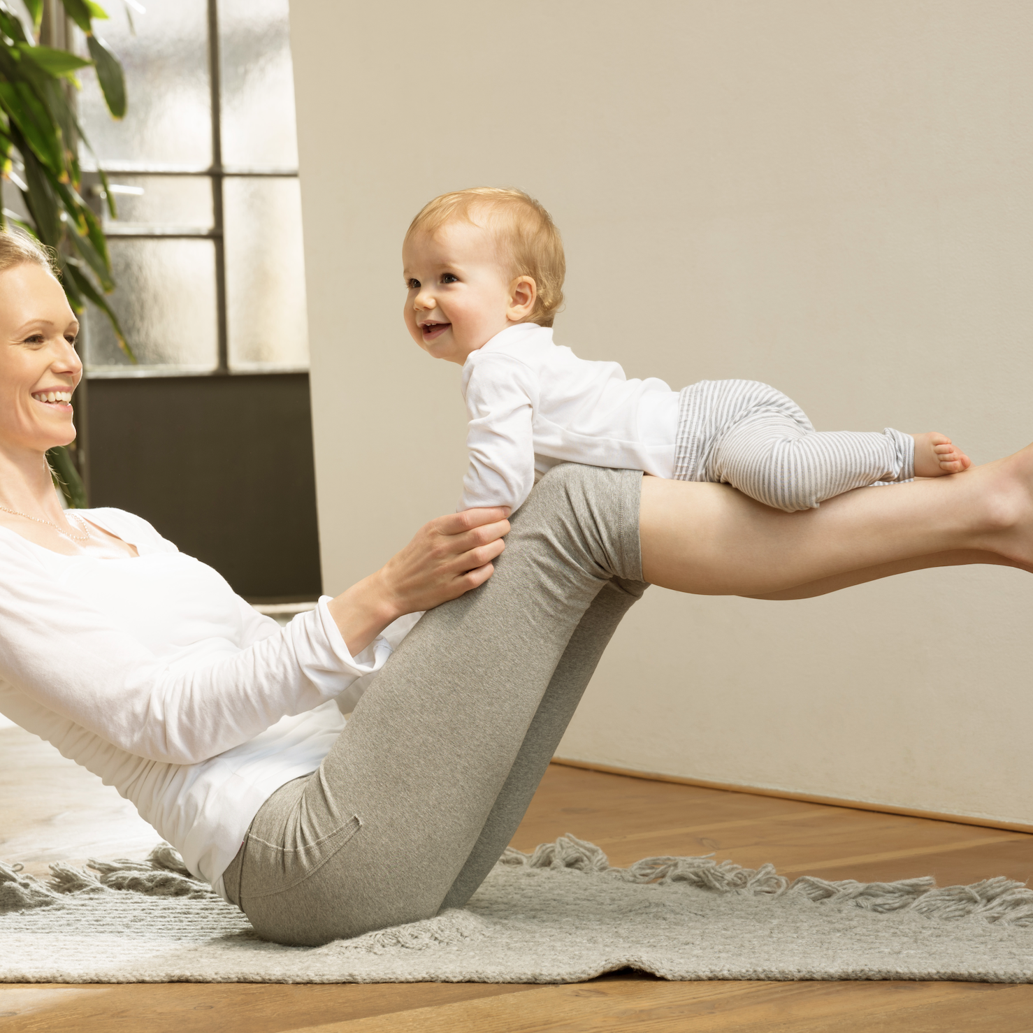 Physical Therapy and Balance Mom balancing baby on knees.