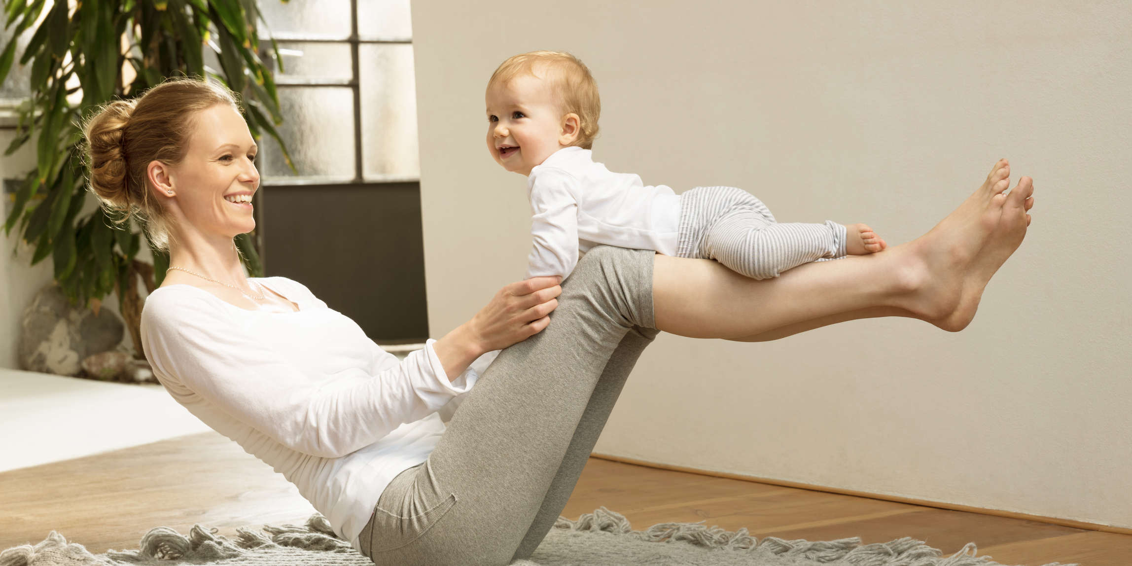 Physical Therapy and Balance Mom balancing baby on knees.
